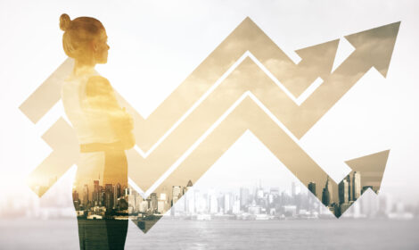 Attractive female on abstract city background with business chart arrows. Double exposure. Success concept
